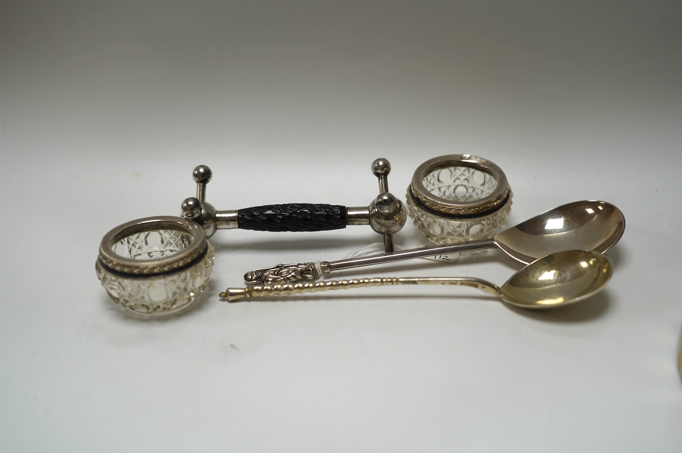 A late 19th century Russian engraved 84 zolotnik spoon, dated 1890, 16.8cm, a George V silver apostle spoon, together with three other items including silver mounted glass salts. Condition - poor to fair to good